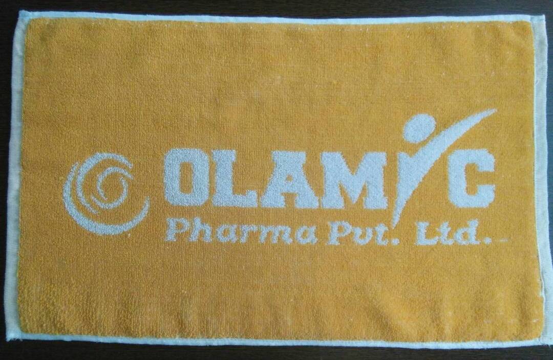 Customized logo towels with company branding by Karuna Textiles